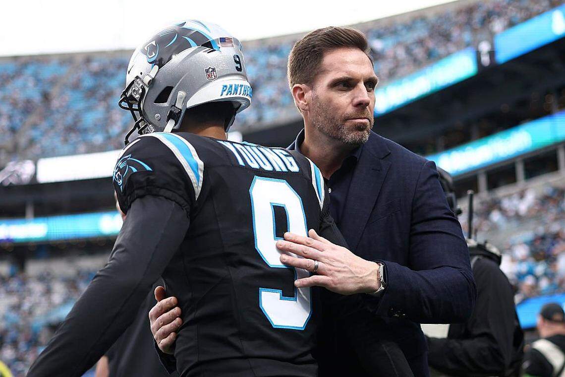 Dan Morgan, president of football operations and general manager for the Carolina Panthers, embraces Bryce Young prior to the NFC Wild Card Playoff game against the Los Angeles Rams at Bank of America Stadium on January 10, 2026 in Charlotte, North Carolina. (Photo by Jared C. Tilton/Getty Images)