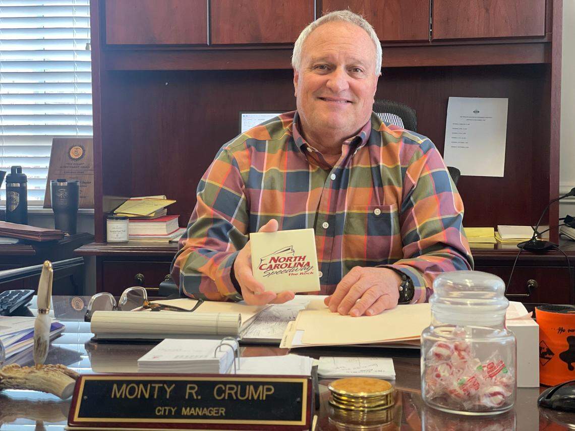 Monty Crump, the city manager of Rockingham, sits behind his desk holding a momento that reads “North Carolina Speedway,” which is what the racetrack was called in the late-90s and early 2000s prior to the NASCAR Cup Series leaving.