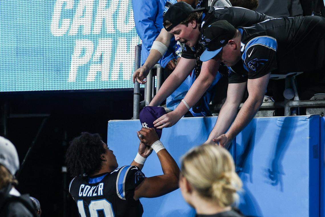 Panthers wide receiver Jalen Coker signs a hat for a fan after a loss to the Rams in a wild-card playoff game, 34-31, on Jan. 10, 2026, at Bank of America Stadium in Charlotte.