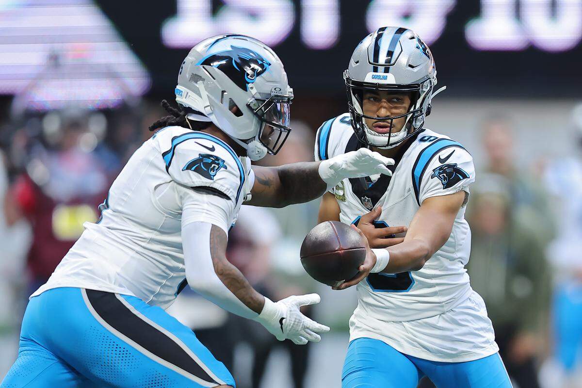Carolina’s Bryce Young hands the ball off to Rico Dowdle during Sunday’s first quarter against the Atlanta Falcons at Mercedes-Benz Stadium in Atlanta. 