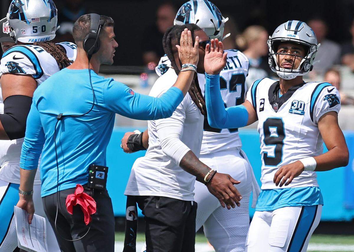 Carolina Panthers head coach Dave Canales, left, reaches out to quarterback Bryce Young following a failed series during action against the Los Angeles Chargers on Sunday.