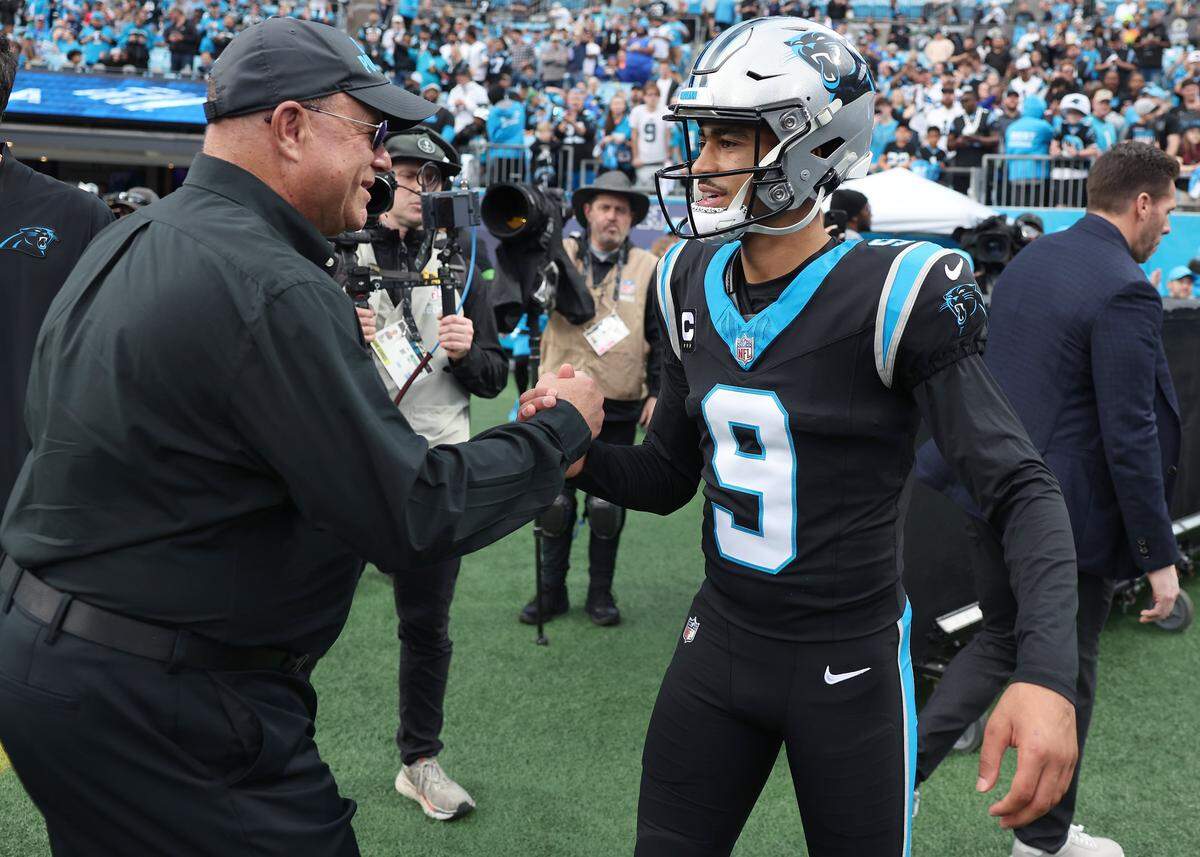 Carolina Panthers team owner David Tepper, left and quarterback Bryce Young, right, greet one another prior to the team’s game against the Los Angeles Rams at Bank of America Stadium on Saturday, January 10, 2026. The Rams defeated the Panthers 34-31.
