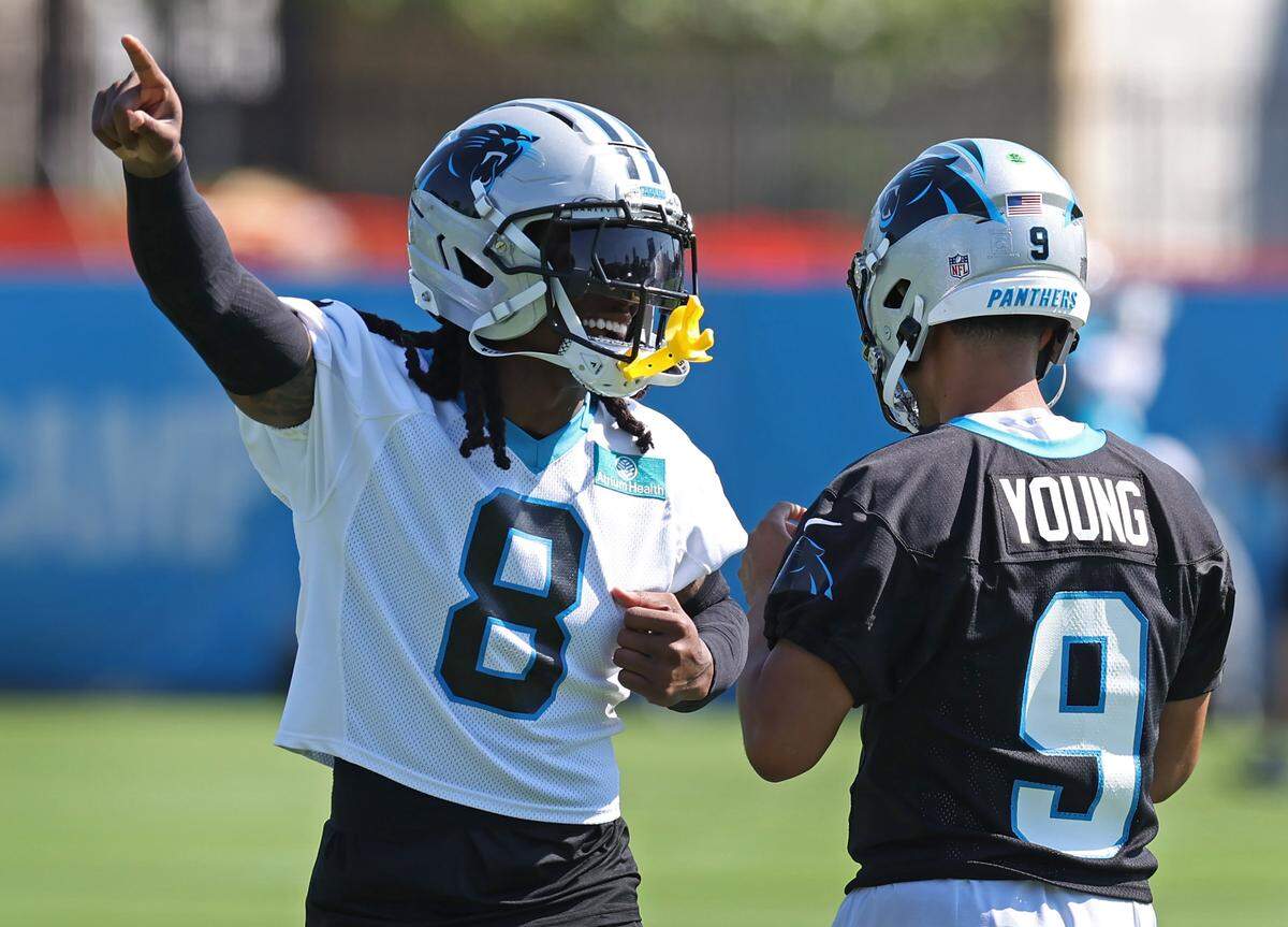 Carolina Panthers cornerback Jaycee Horn, left, jokes around with quarterback Bryce Young, right, during a July, 2025, training camp practice.