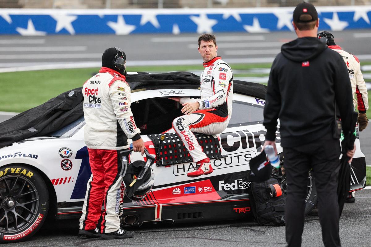 NASCAR Cup Series driver Denny Hamlin exits his car as a rain delay briefly stops the Coca-Cola 600 on Monday, May 29, 2023 at Charlotte Motor Speedway.
