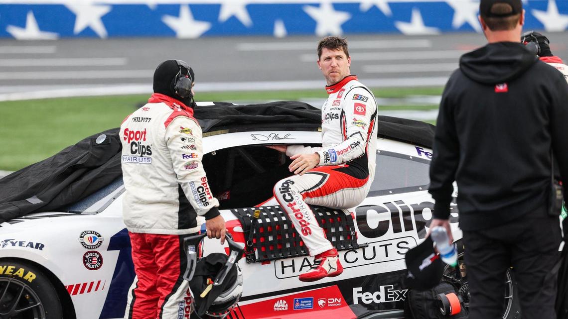 NASCAR Cup Series driver Denny Hamlin exits his car as a rain delay briefly stops the Coca-Cola 600 on Monday at Charlotte Motor Speedway.