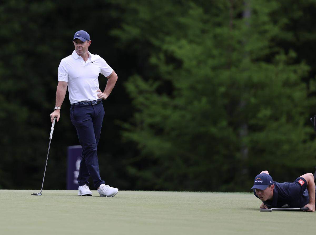 Rory McIlroy of Northern Ireland, left, waits as Matt Fitzpatrick of Sheffield, England lines up a putt during the 2026 Truist Championship at the Quail Hollow Club in Charlotte on Thursday, May 7.
