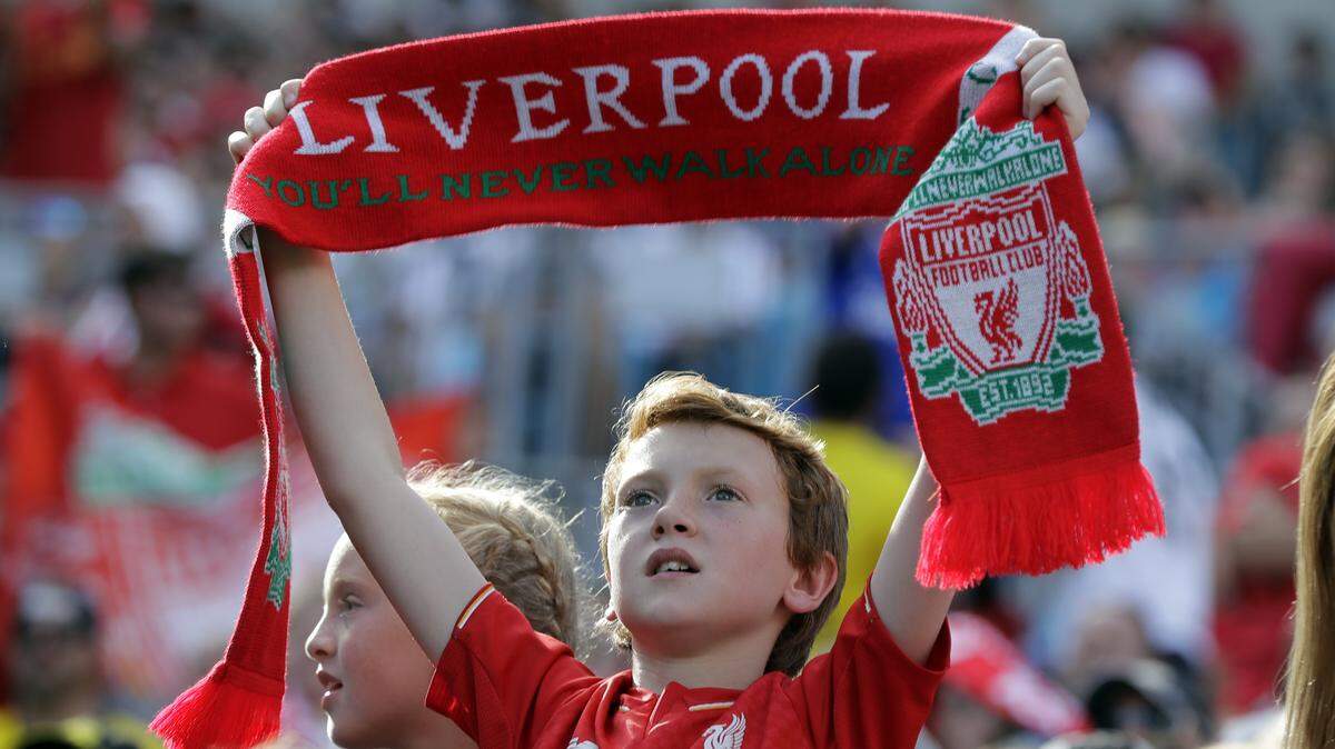 A Liverpool fan cheers during an International Champions Cup tournament soccer match against Borussia Dortmund in Charlotte, N.C., Sunday, July 22, 2018. (AP Photo/Chuck Burton)