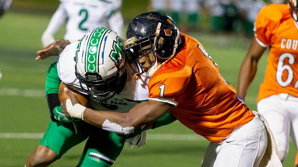 Vance Cougar linebacker Power Echols (1) tackles Myers Park wide receiver Andre Francois (left).
