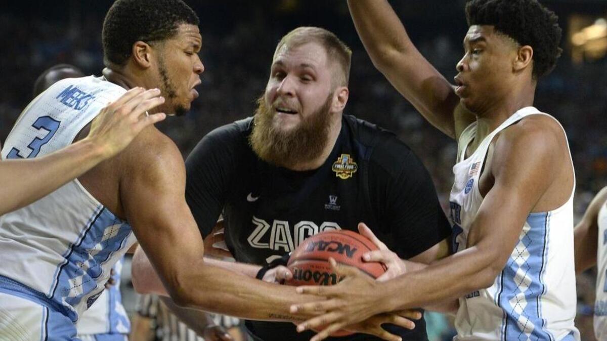 Two veteran NBA reporters say that UNC forward Kennedy Meeks (3) and teammate UNC forward Isaiah Hicks (4) -- seen playing Gonzaga center Przemek Karnowski (24) in the 2017 NCAA finals -- have agreed to NBA free agent deals