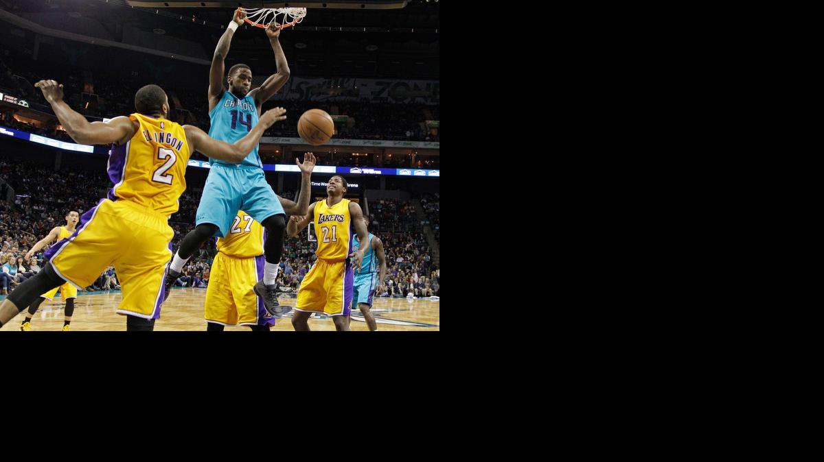 
Charlotte Hornets' Michael Kidd-Gilchrist (14) dunks against Los Angeles Lakers' Wayne Ellington (2) during the second half of an NBA basketball game in Charlotte, Tuesday, March 3, 2015. The Hornets won 104-103. 
