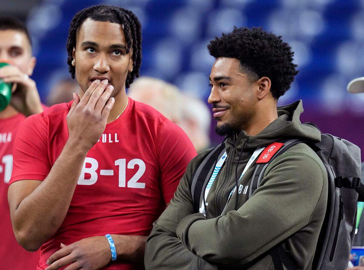 FILE - Ohio State quarterback CJ Stroud, left, talks to Alabama quarterback Bryce Young at the NFL football scouting combine in Indianapolis, Saturday, March 4, 2023. The Panthers packaged two first-round picks, two second-round picks and star receiver D.J. Moore to move up from No. 9 in the draft to the top pick to give Carolina the pick of the lot at quarterback in next week’s draft. (AP Photo/Darron Cummings, File)