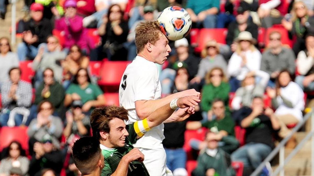 Hough's Pablo Garza (left) looks on as Cardinal Gibbons' Jack Zarnik (center) defends the header by Hough's Trey McAfee. The Cardinal Gibbons Crusaders beat the Hough Huskies 2-1 in the NCHSAA 4A mens soccer championship game, November 18, 2017 in Raleigh.