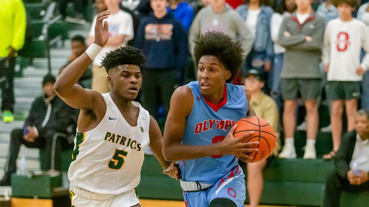 Olympic’s Josh Banks (3) drives the baseline and is fouled.