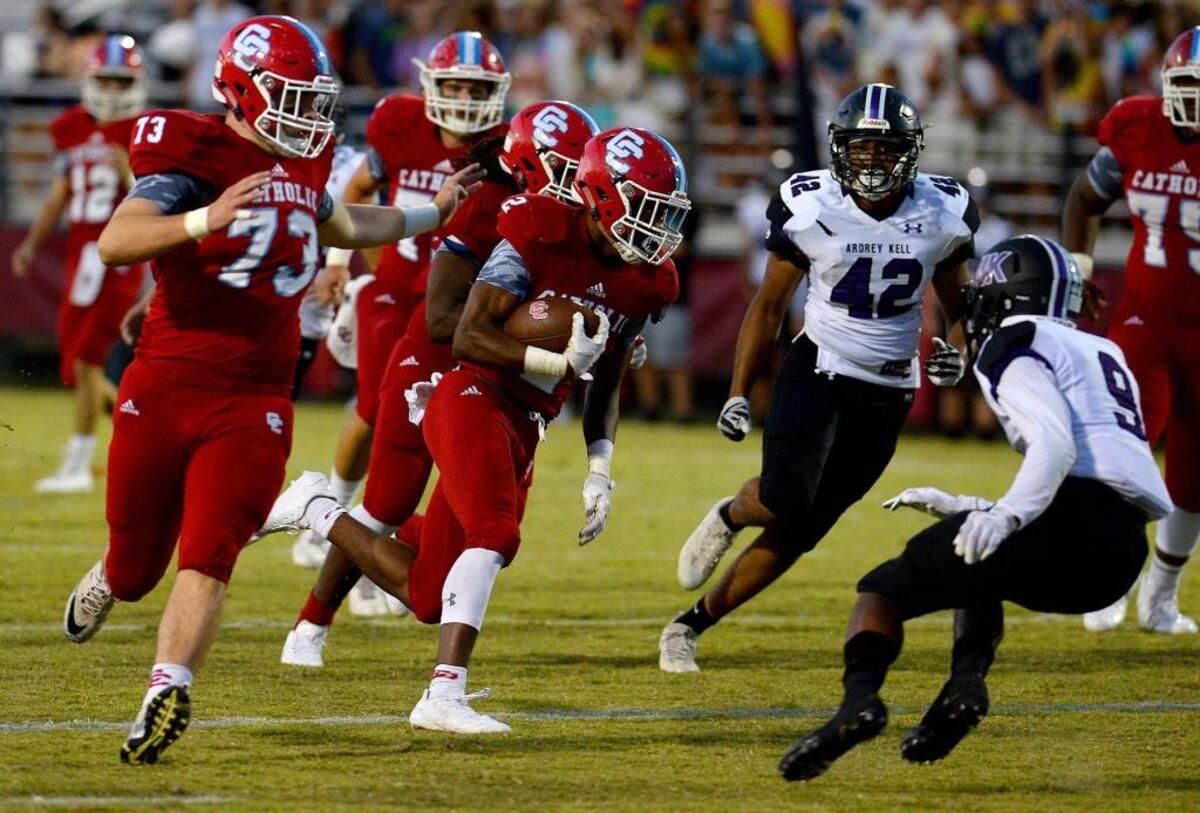 Charlotte Catholic running back Milan Howard, center, breaks back to the middle on a touchdown run during first quarter action against Ardrey Kell on Friday, September 8, 2017.