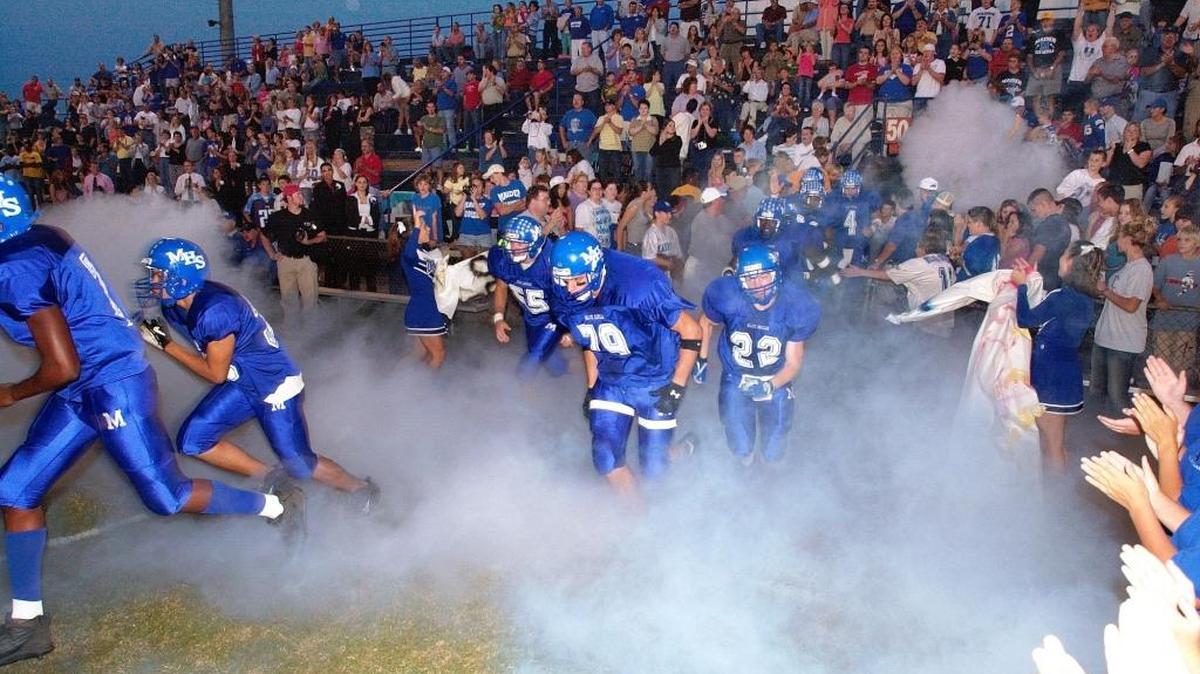 With the stands filled with fans, Football Friday Night kicks off with the beloved Blue Devils coming from the tunnel in a cloud of smoke.

 Photo by Robert Padgett/ Special to the Charlotte Observer