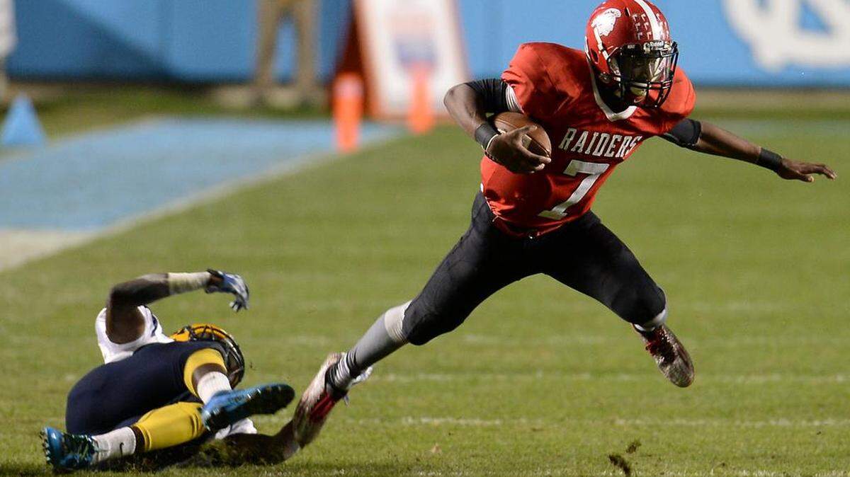 South Point quarterback Diontre King tries to escape the reach of a Rocky Mount defender during second quarter action in the NC 3A Championship game at Kenan Memorial Stadium in Chapel Hill, NC on Friday, December 11, 2015.