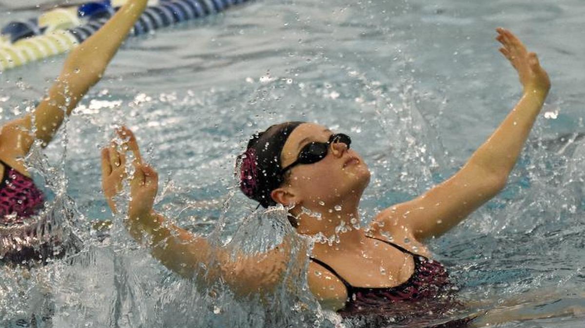 Olivia Schafer, right, a 14-year-old Pine Lake Prep student, works on a routine with duet teammate Marian Catahan, 13 and also a Pine Lake Prep student, during a training session with Carolina Synchro coach Anne Schulte at the Huntersville Family Fitness and Aquatic Center . Schafer qualified in three events in the 13-15 division for the U.S. National Synchronized Swimming Championships, scheduled for April 6-9 in Mesa, Ariz.