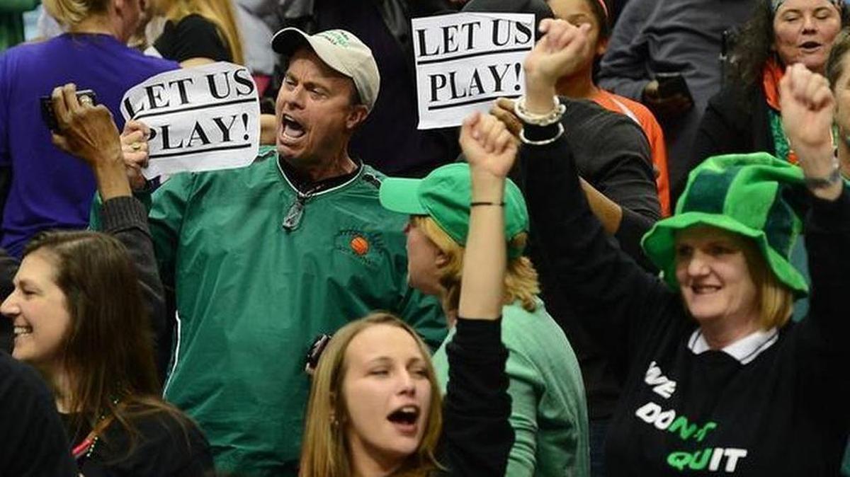 Fans of the Myers Park Mustangs hold signs reading "Let Us Play" following the team's victory over Southeast Raleigh in the NCHSAA 4A Girls Championship game at the Dean E. Smith Center in Chapel Hill, NC on Saturday March 14, 2015. Myers Park defeated Southeast Raleigh 52-47 but the NCHSAA denied its appeal Tuesday to play in the Dick's Sporting Goods National tournament.