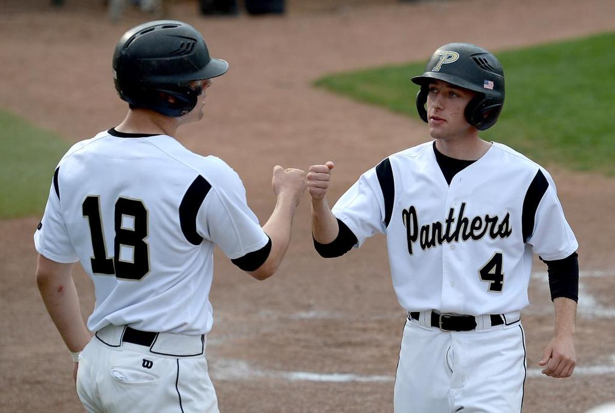 Providence Panthers Patrick Bloomingburg, left and Jack Roth, right, congratulate one another after both scored during first inning action against the Weddington Warriors on Tuesday, April 3, 2018. The teams were participating in the Queen City Classic Easter Baseball Tournament at Providence High School.