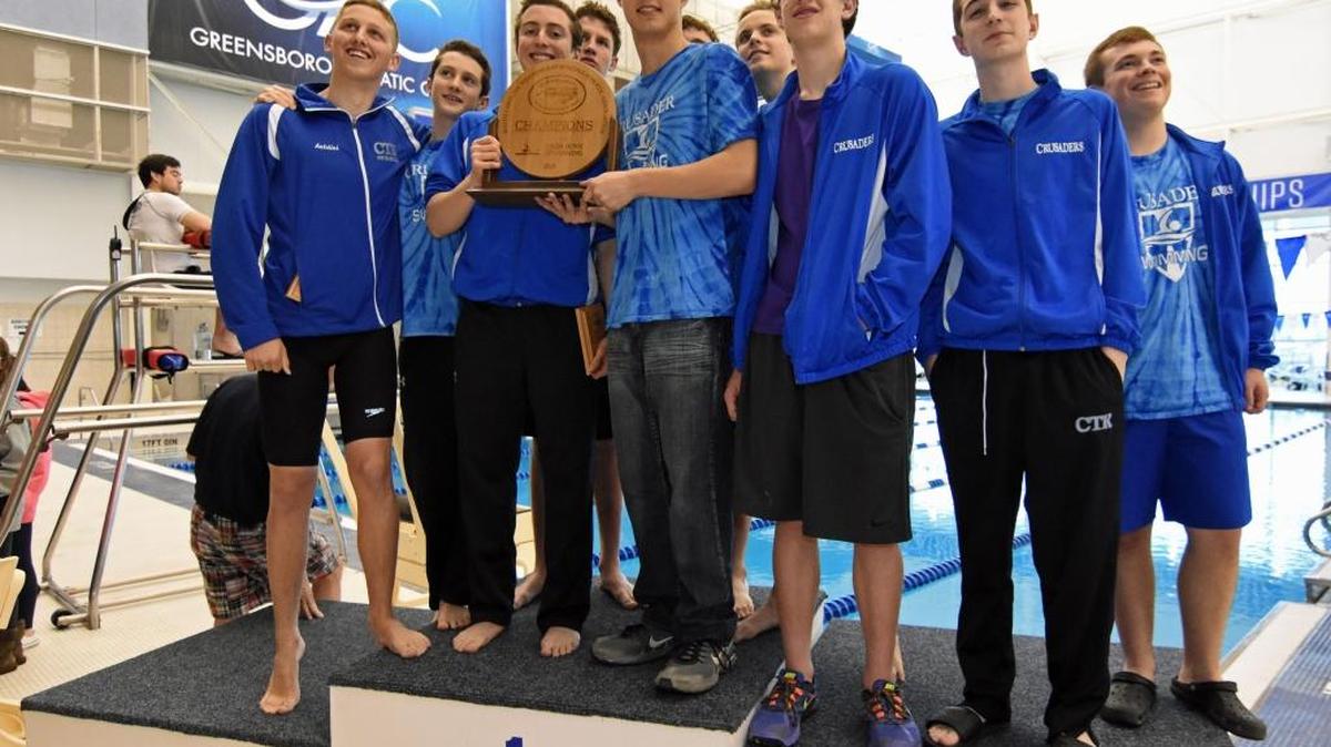 The members of Christ The King Catholic High School's boys swimming team hold their trophy after winning the N.C. Independent Schools Athletic Association (NCISAA) 1A/2A state title Monday, Feb. 22, 2016, at the Greensboro Aquatic Center in Greensboro, N.C. CREDIT: Bill Kiser/Special to the Observer