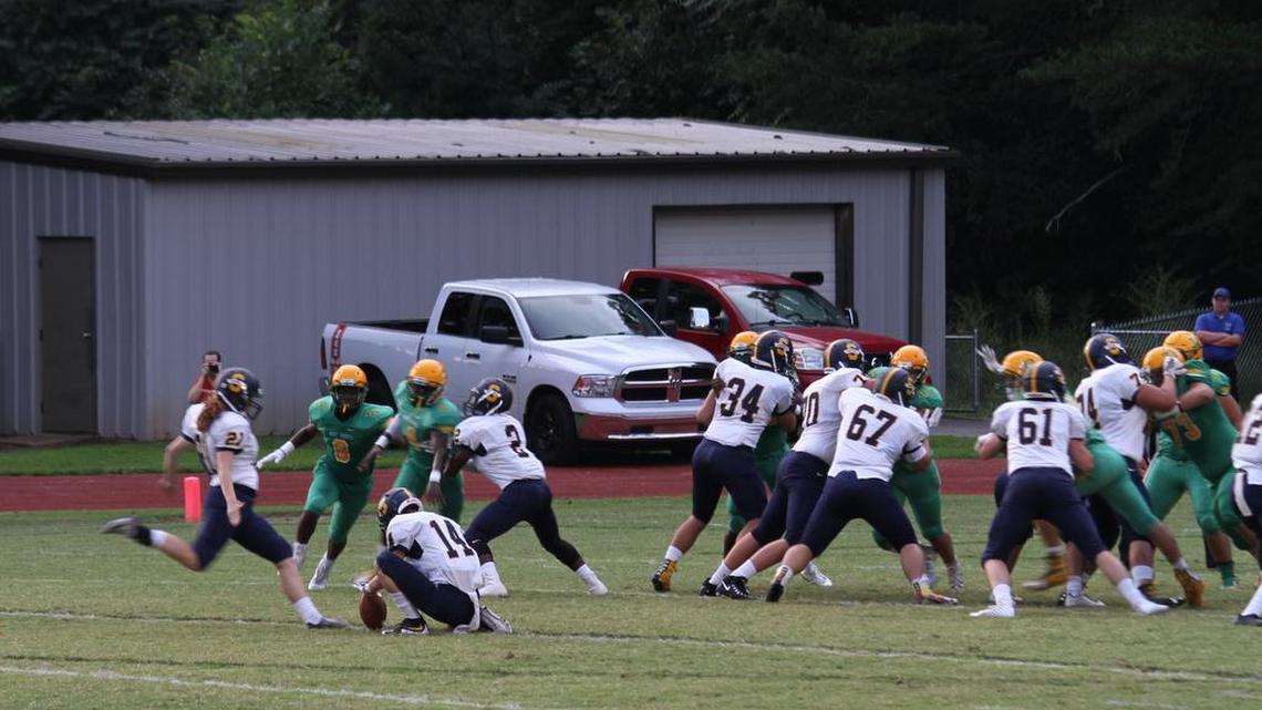 Julia Knapp, South Iredell Football, at left, kicking the football.