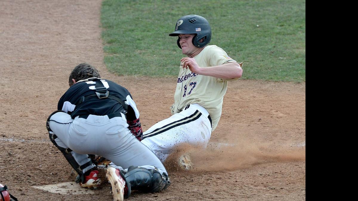 
 From left, Butler's catcher Jarrett Norman tags out at home plate Providence high's runner Tucker Jones during game 1 of NCHSAA 4A Western Regional baseball game played at Providence High May 26,2015.
