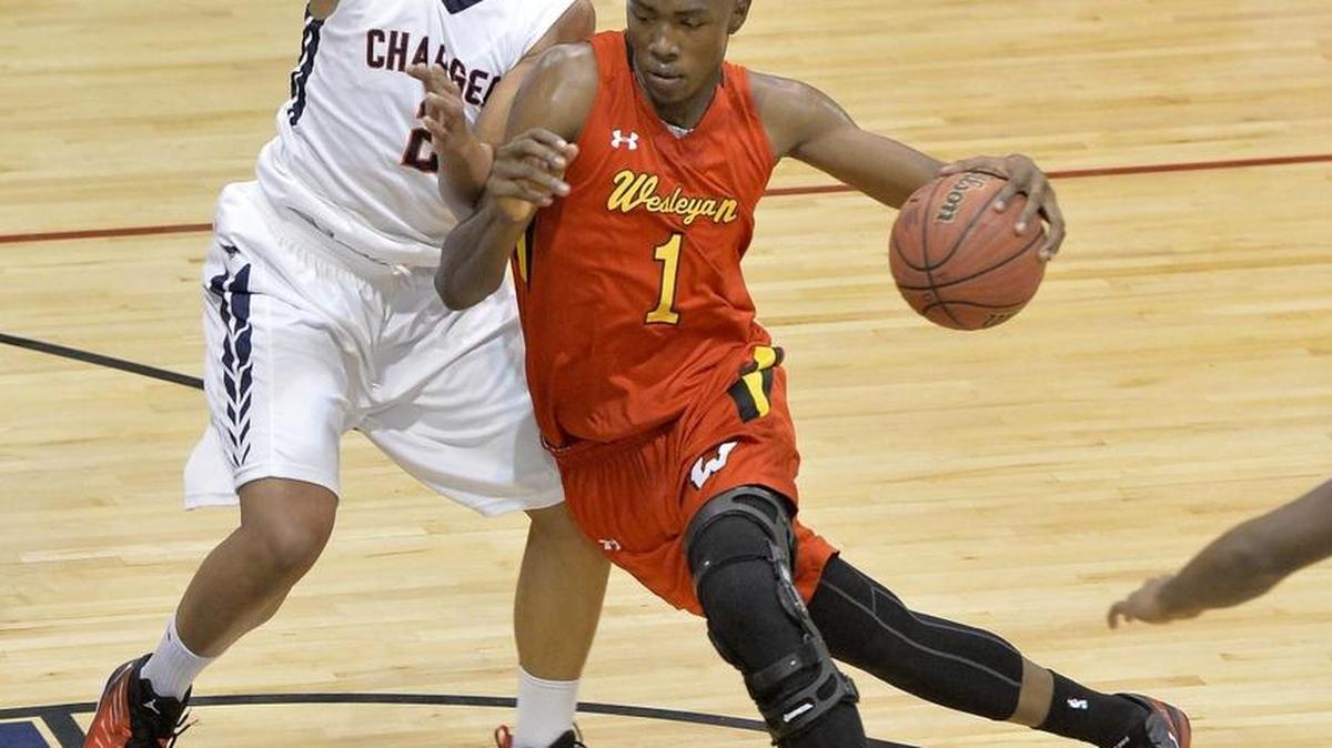 Wesleyan's Harry Giles (right), drives the ball to the basket against Providence Day's Grant Williams (left),during Tuesday night's game played at Providence Day School Nov. 18,2014.