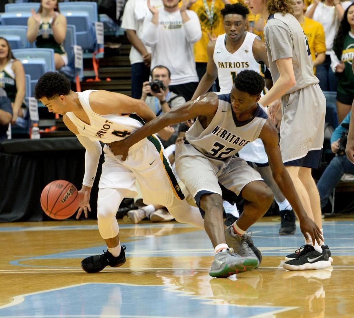 Independence #4 Raja Milton, right, steals the ball from Heritage #32 Jarren McAllister during Saturday evening's NCHSAA state basketball championship 4A game between Independence and Wake Forest Heritage at the Smith Center in Chapel Hill.