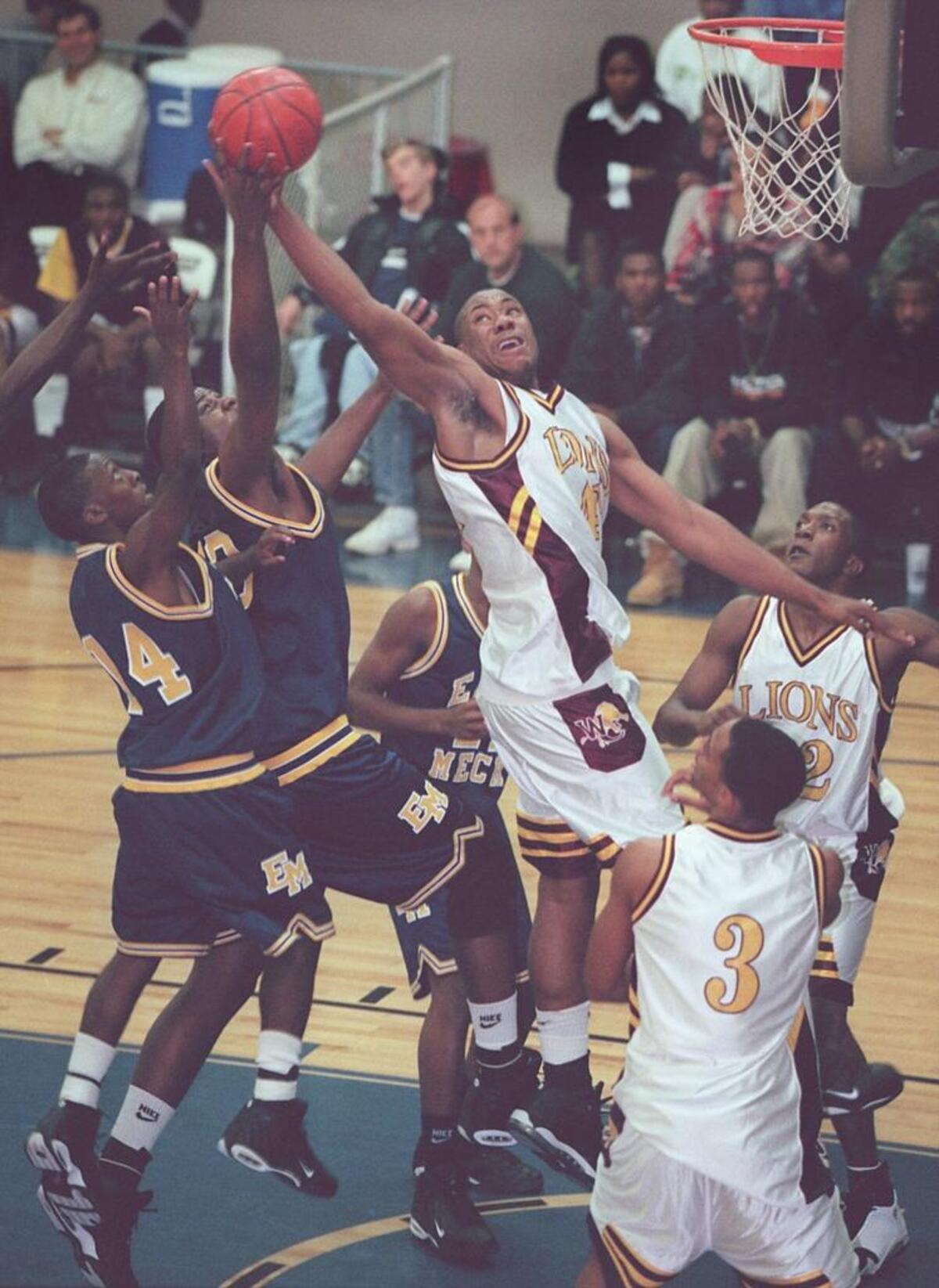 In a marquee game in the 1998-99 season, West Charlotte’s Jason Parker pulls down a rebound over East Mecklenburg at the Grady Cole Center. Parker and West Charlotte would go on to win the 4A boys’ state championship.