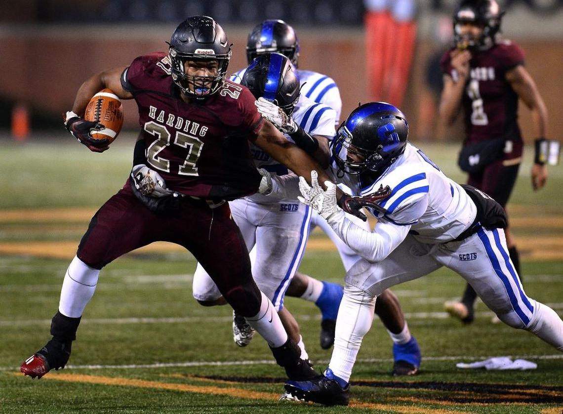 Harding University running back Quavaris Crouch, left, battles to get free of a Scotland County defender on a run during first-half action in the NCHSAA 4A state Championship game at BB&T Field in Winston-Salem, NC on Saturday, December 9, 2017.