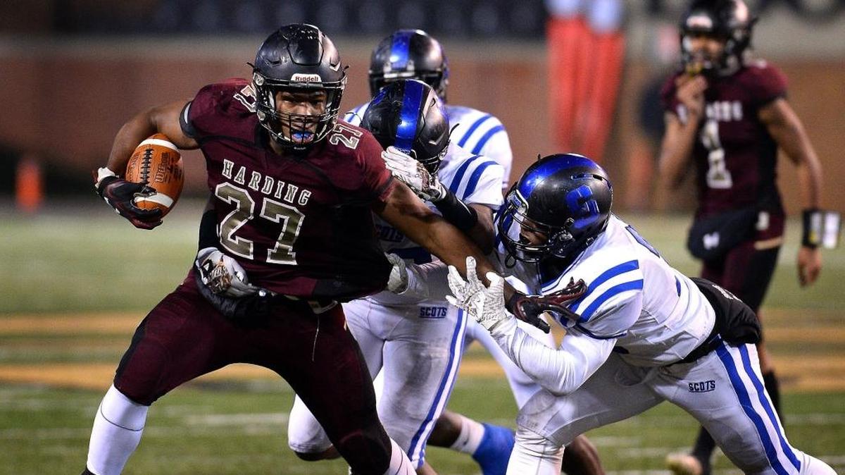 Harding University running back Quavaris Crouch, left, battles to get free of a Scotland County defender on a run during first-half action in the NCHSAA 4A state Championship game at BB&T Field in Winston-Salem, NC on Saturday, December 9, 2017.