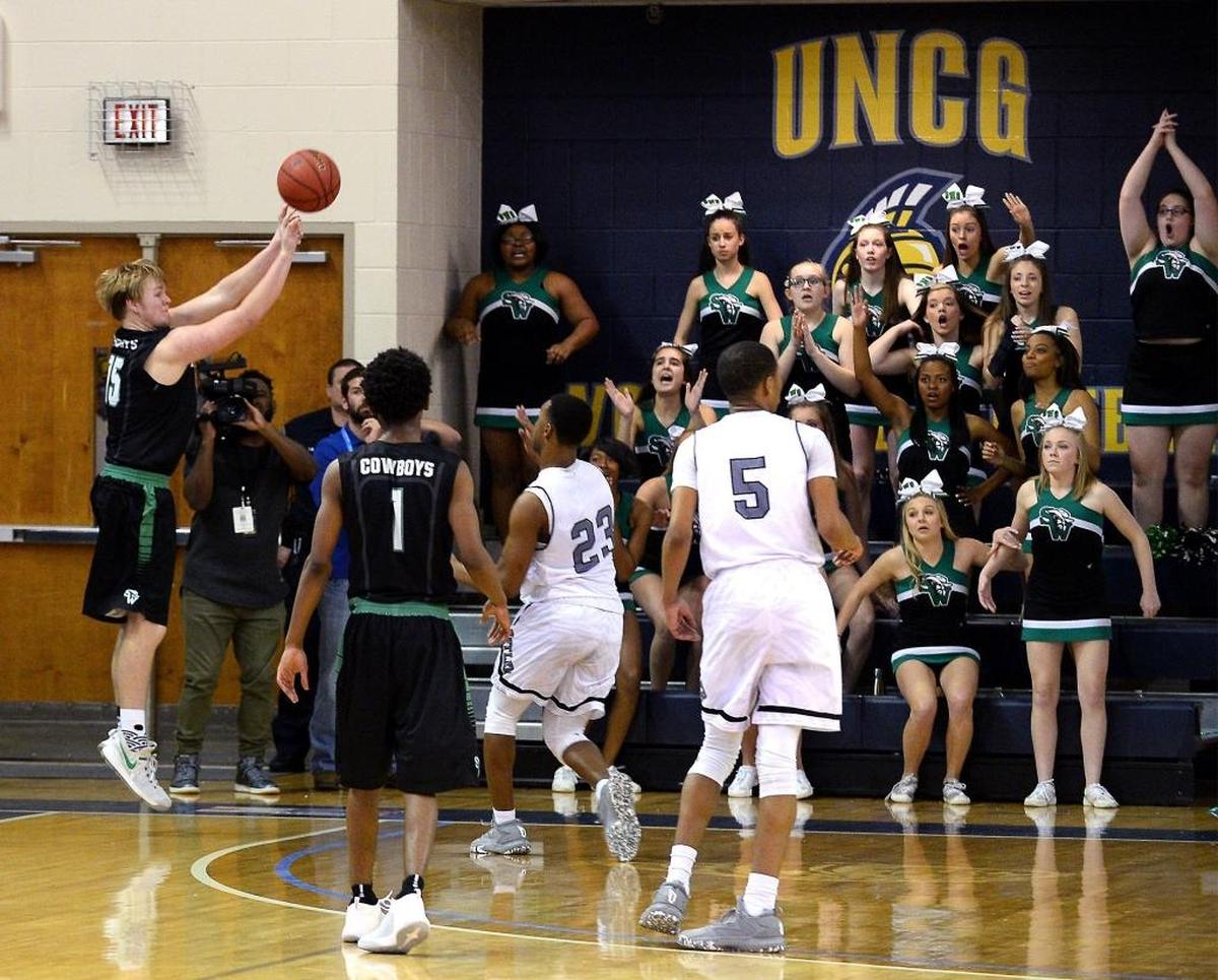 Southwest Guilford's Cooper Cunningham, left, releases the game-winning 3-pointer against Butler Bulldogs in the N.C. 4A Western Regional Championship game in March. Southwest Guilford won 61-58.
