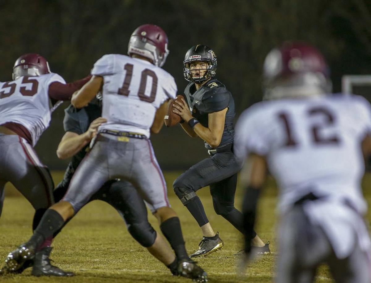 Providence quarterback Mason Boothe looks to pass against West Mecklenburg Friday night. Providence won 48-8.