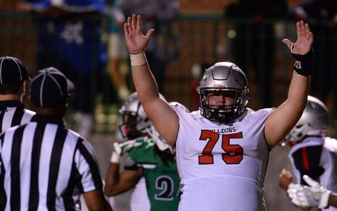 Butler Bulldogs offensive lineman Cam Taylor raises his arms to signal a touchdown run by half back Keyon Lesane during fourth-quarter action against Myers Park on Friday, Oct. 6, 2017 at Myers Park High School. Butler defeated Myers Park 28-7.
