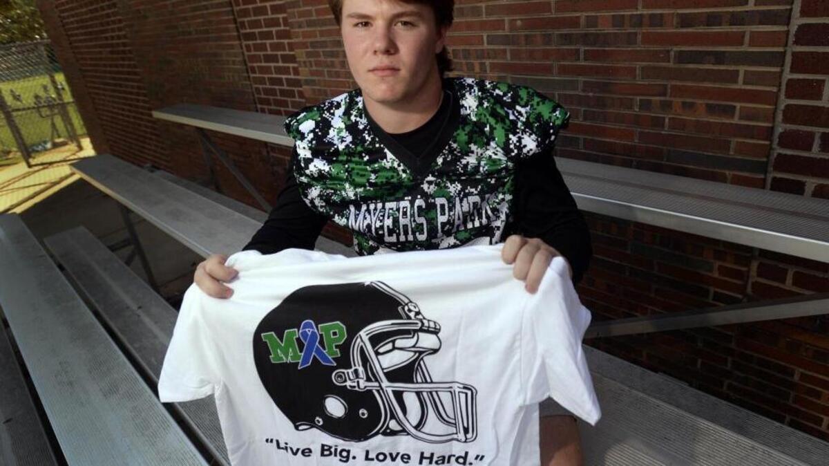 Myers Park defensive back Geyer Withers displays a T-shirt that the school is selling in honor of his mother, Leta Ann Morris Withersmom, who died of cancer in July.