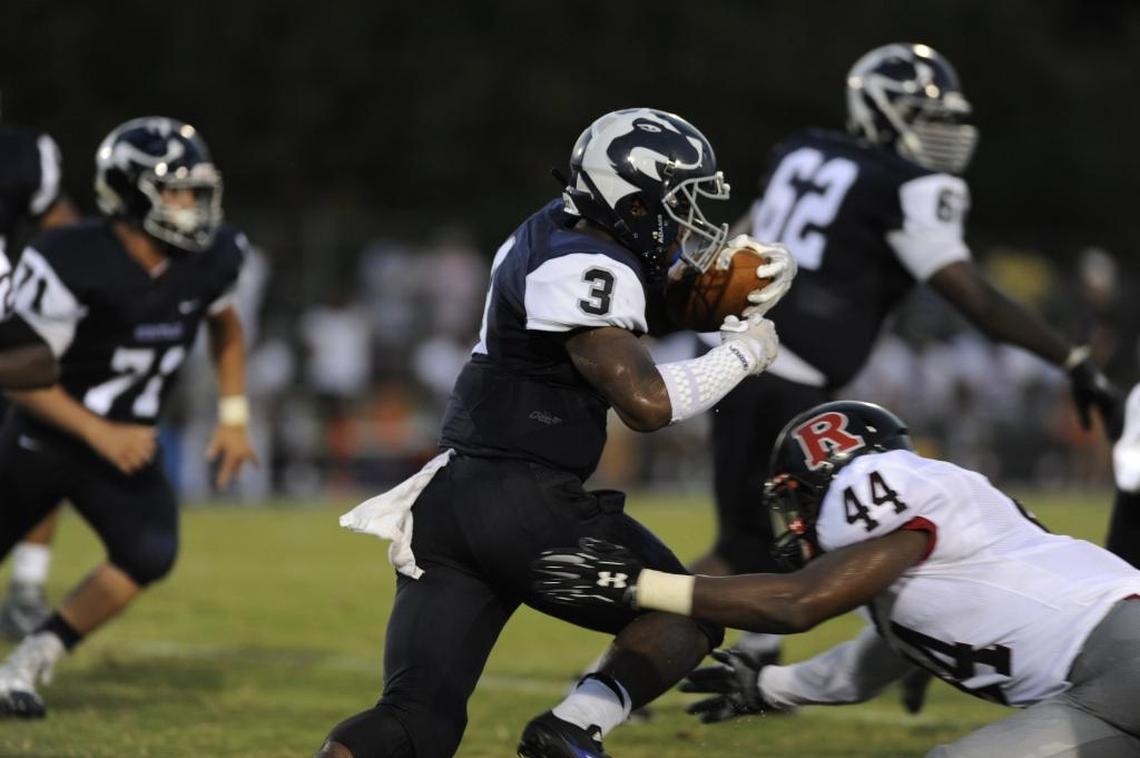 Heritage running back Ricky Person makes a Rolesville football player miss.