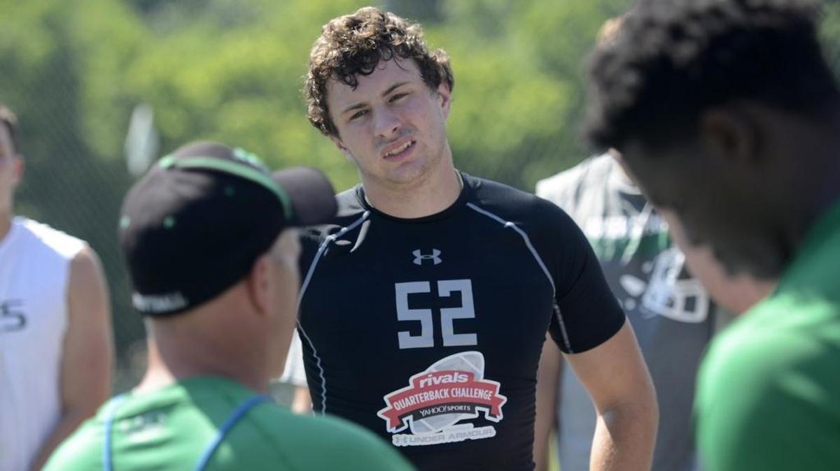 Brayden Hawkins, a senior quarterback for Myers Park High, listens as coach Scott Chadwick addresses the team after practice. Chadwick praises Hawkins’ work ethic and willingness to learn.