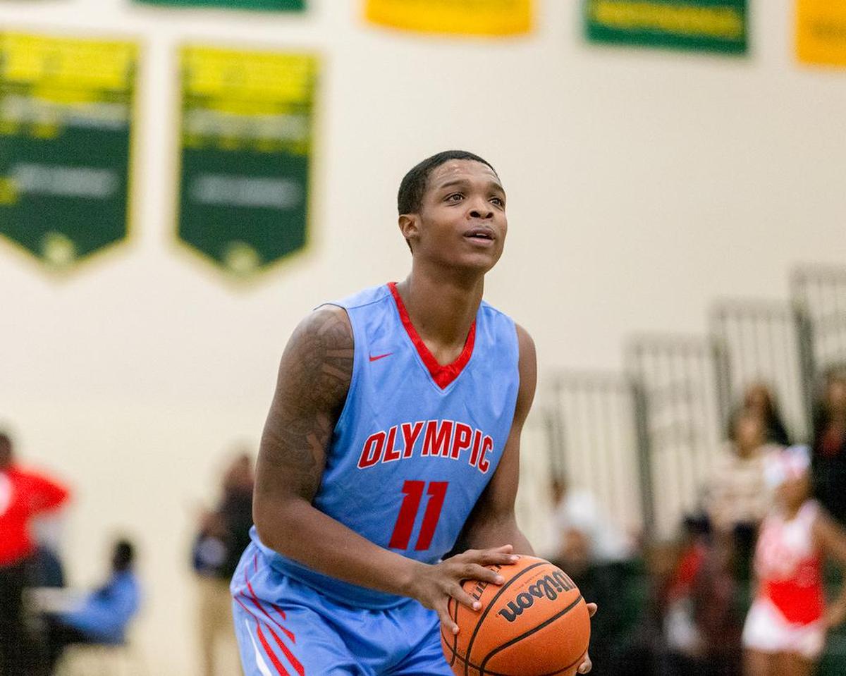 Olympic's Deonte Randolph (11) shoots 2 free throws during late 1st half action.