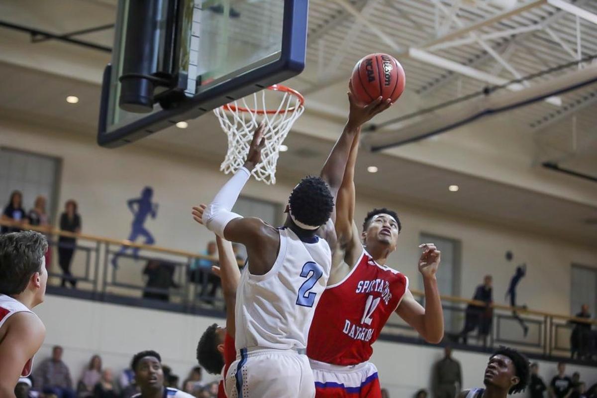 Spartanburg Day's Matt Brown (10) goes up for the monster block against Gaston Day's Nate Hinton (2) during late first half action.