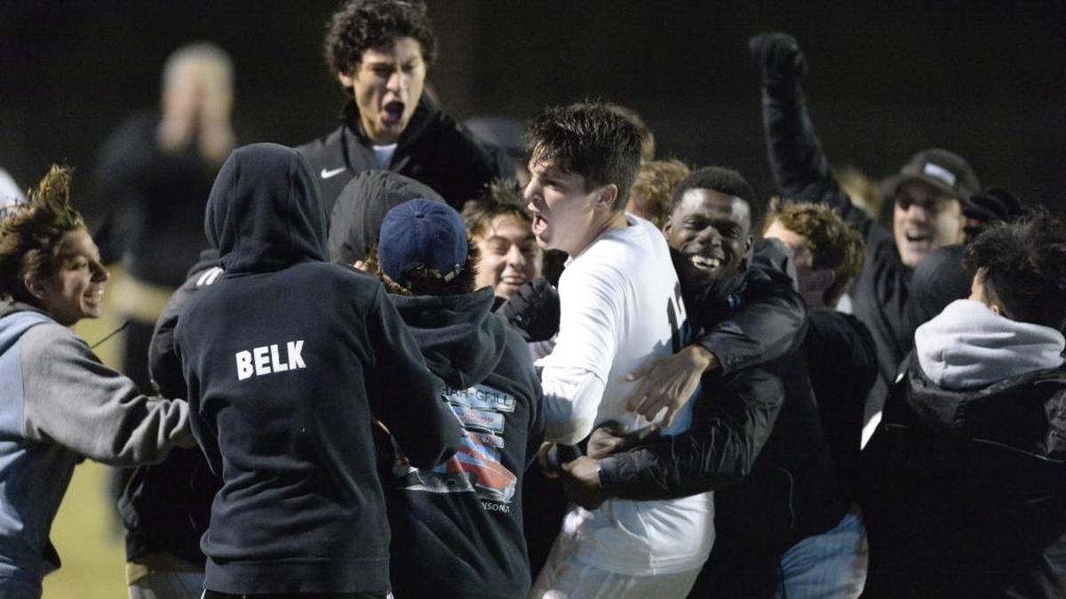 Providence’s Joey Dalrymple (12) celebrates with teammates on the bench after scoring Wednesday against South Meck in a third-round NCHSAA 4A playoff match. Providence won, 1-0.