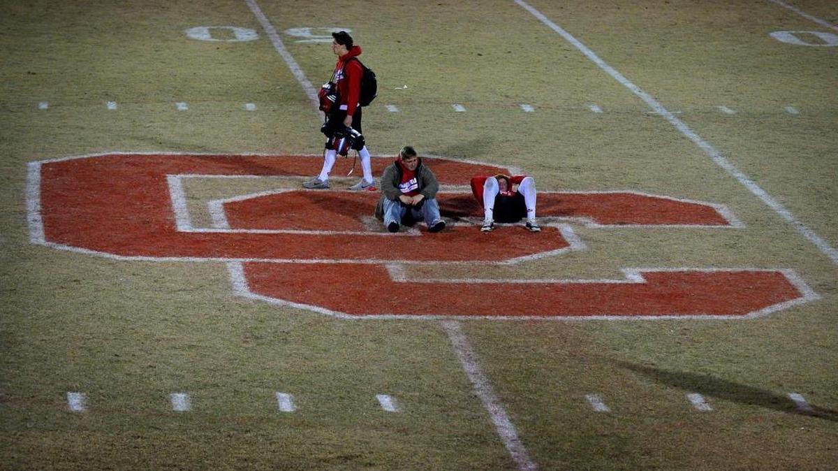Charlotte Catholic football players gather at midfield following their home loss to Greensboro Dudley Friday night. Dudley won 21-10 to advance to next week’s 4A state championship game.