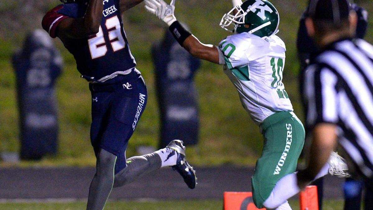 Mallard Creek Mavericks wide receiver Ryan Jones, left, catches a touchdown pass as A.L. Brown cornerback Shymere Scott, right, applies pressure during second quarter action on Friday, October 23, 2015 at Mallard Creek High School.