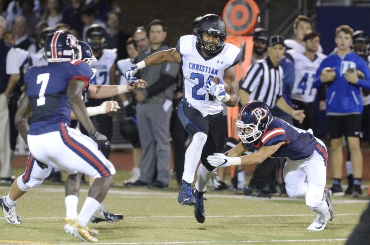 Charlotte Christian's Justus Woods (21) runs past Providence Day defenders during their game on Friday, October 27, 2017.