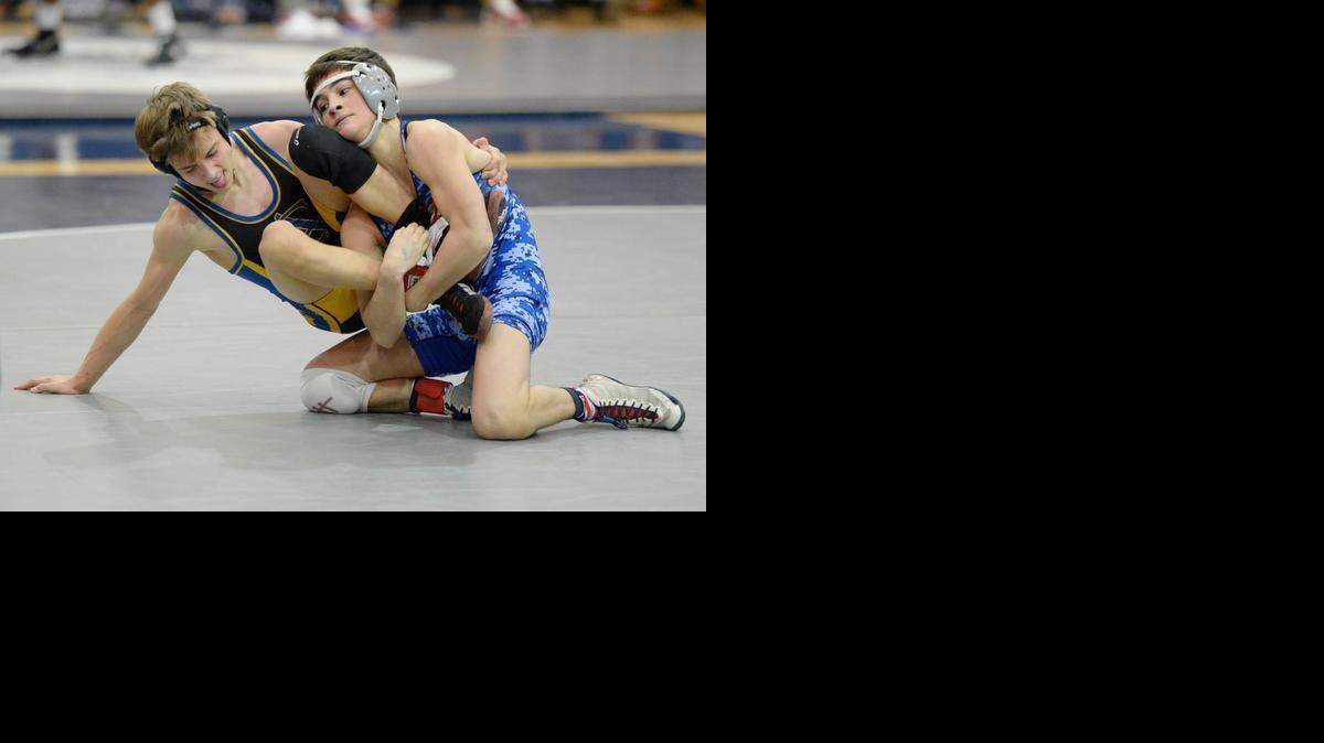 
Charlotte Latin's Michael McClelland (right) gains control of Cary Acadeny's Christian Sodano in the the championship match of the 106-lbs class of the N.C. Independent Schools Athletic Association state wrestling tournament at Charlotte Latin.
