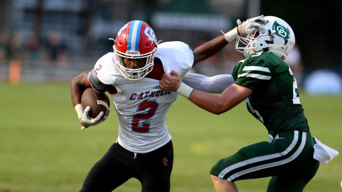 Charlotte Catholic's Howard Milan, left, is among this week’s Charlotte Observer high school football players of the week.