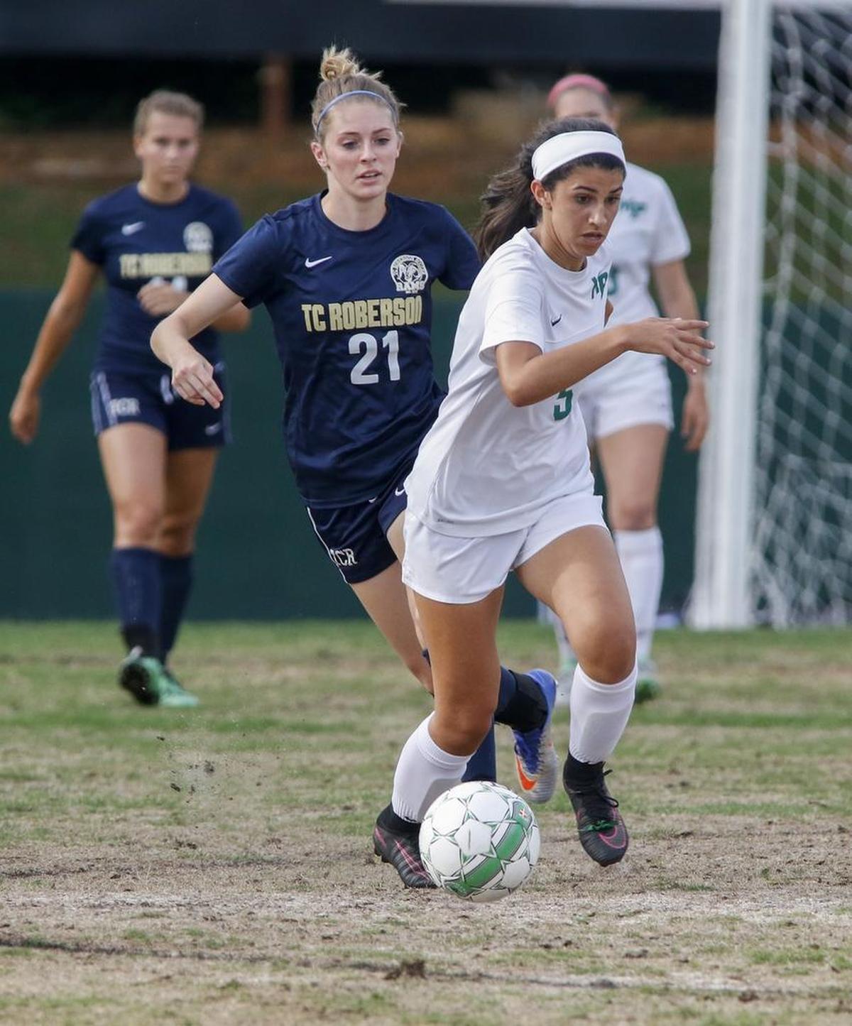 Myers Park forward Ari Maibodi pushes the ball upfield ahead of T.C. Roberson defender Claire Grefe in the third round of the N.C. 4A girls’ soccer playoffs on Wednesday in Charlotte. Myers Park won 5-0.