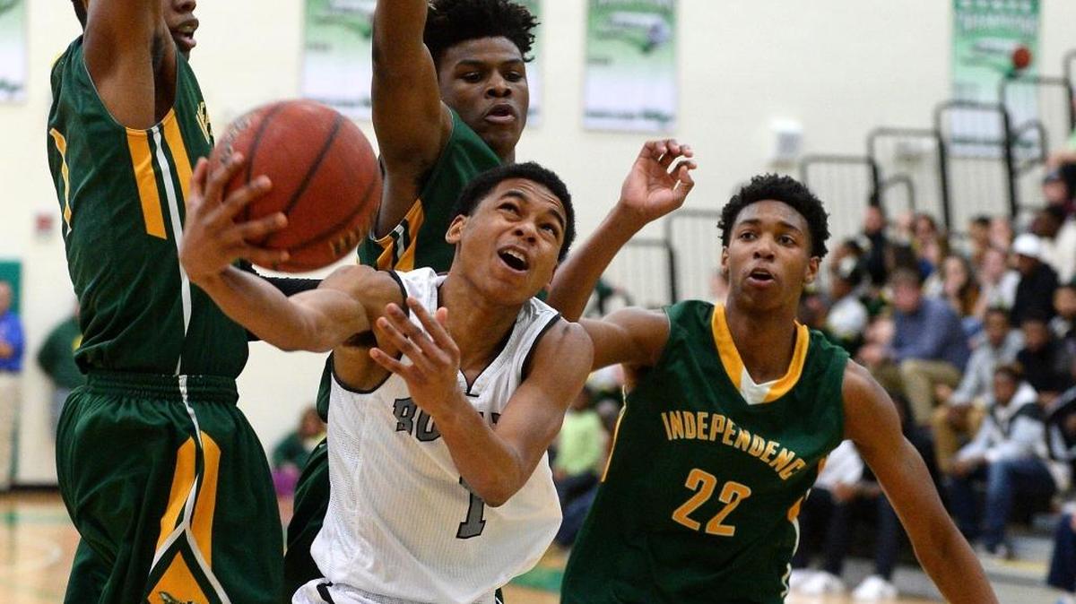 Butler Bulldogs Omega Stitt, center, drives past the Independence Patriots defense for a shot in the lane during the Southwestern 4A championship game action at Myers Park High School on Friday, February 17, 2017. The Bulldogs defeated the Patriots 62-37.