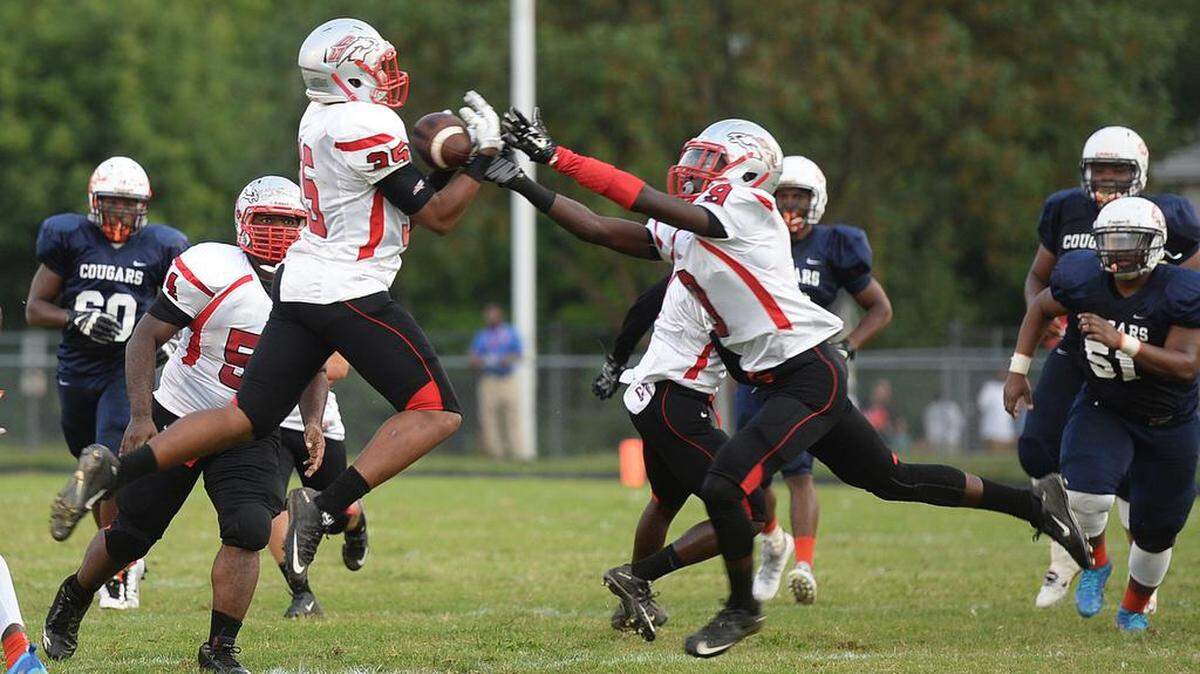 
South Pointe Zy Williams, left, recovers a tipped pass from Vance for an interception as teammate Shaveres Crockett (9) also reaches for the ball during Friday’s No. 5 South Pointe at No. 1 Vance non-conference high school football game.
