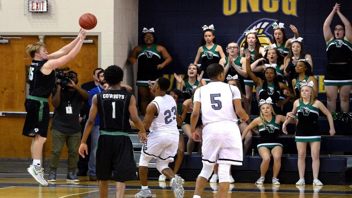 Southwest Guilford's Cooper Cunningham, left, releases the game winning 3-point basket against the Butler Bulldogs during Saturday’s NCHSAA 4A Western Regional Championship game. Southwest Guilford defeated Butler 61-58.