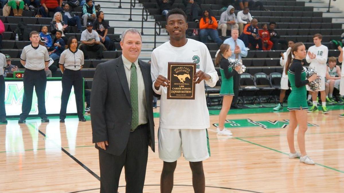 Myers Park coach Wes Hepler, seen here in a photo with former Mustang Zaqwaun Matthews, is leaving the school to take a job at North Gaston High